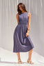 Woman wearing a purple dress against a white background