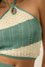 Teal and white knitted top with thin straps on a neutral background