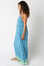Woman wearing a blue and green striped dress on a white background
