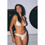 Woman wearing a white bikini with vertical stripes against a neutral background