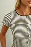 Close-up of a person wearing a black and white striped shirt with a plain background