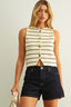 Woman wearing a striped sleeveless top and denim shorts against a plain background