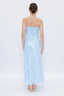Woman wearing a light blue strapless dress with a white background