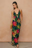 Woman wearing a colorful floral dress against a beige background