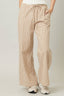 Beige striped pants worn by a person on a plain background