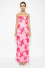Woman wearing a pink floral dress on a white background
