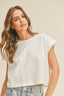 Woman wearing a white t-shirt against a beige background