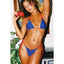Woman in a blue and red bikini holding a red camera in a tropical setting.