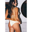 Woman wearing a white bikini with a minimal background