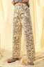 Floral-patterned pants worn by a person on a beige background
