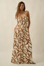 Woman wearing a patterned dress on a beige background