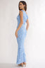 Woman wearing a light blue lace dress on a white background