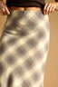 Plaid skirt with a neutral color palette on a beige background