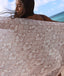 Person holding a patterned towel with a beach in the background