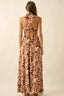 Woman wearing a patterned halter neck dress on a beige background