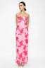 Woman wearing a pink floral dress on a white background