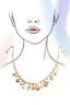 Gold necklace with charms on a stylized face with a light blue background
