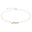 Delicate gold bracelet with small white beads on a white background