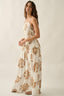 Woman wearing a floral dress on a plain background