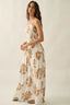 Woman wearing a floral dress on a plain background