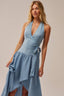 Woman wearing a blue dress against a neutral background