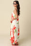 Woman wearing a floral dress with red flowers on a beige background