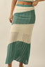 Knitted skirt with green and beige pattern on a neutral background