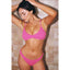 Woman wearing a pink bikini against a tiled wall.