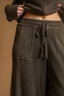 Brown ribbed sweater and pants set on a beige background