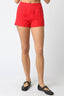 Red shorts worn by a person on a white background