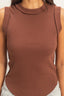 Brown sleeveless top worn by a person on a plain background
