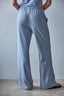 Person wearing blue striped pants against a gray background