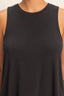 Black sleeveless top worn by a person on a neutral background