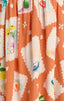 Patterned fabric with colorful designs on an orange background