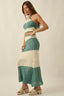 Woman wearing a green and white crochet dress on a beige background