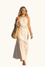 Woman in a coastal beige halter cut out maxi dress
