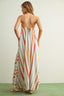 Woman wearing a striped maxi dress with a plain background