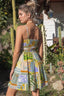 Woman wearing a colorful dress in a garden setting