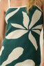 Close-up of a green and white patterned dress with floral design.