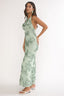 Woman wearing a green floral dress on a white background