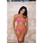 Woman wearing a pink bikini against a tiled wall.