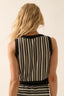 Person wearing a black and white striped sleeveless dress on a plain background