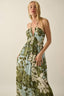 Woman wearing a floral dress against a plain background
