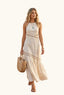 Woman in a coastal beige halter cut out maxi dress