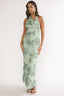 Woman wearing a green floral dress on a white background