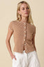 Woman wearing a brown and white striped shirt with buttons on a beige background