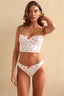 Woman wearing a floral bikini set against a beige background