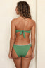 Woman wearing a green bikini against a beige background