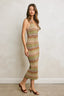 Woman wearing a patterned dress against a plain background