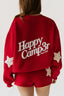 Red sweatshirt with 'Happy Camper Since 2021' text and star designs on a plain background